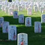 Picture of graves decorated with flags at Arlington National Cemetery on Memorial Day